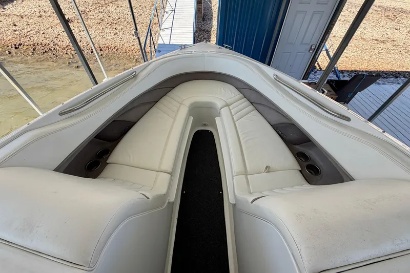 Slide: The Image of 2005 Cobalt 282 boat interior with white leather seating and cup holders. - 13
