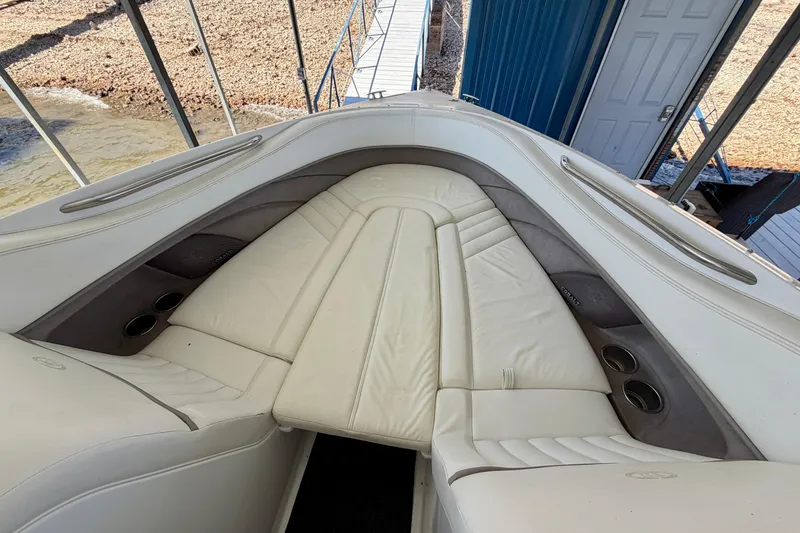 Slide: The Image of 2005 Cobalt 282 boat interior with white leather seating and cup holders. - 14