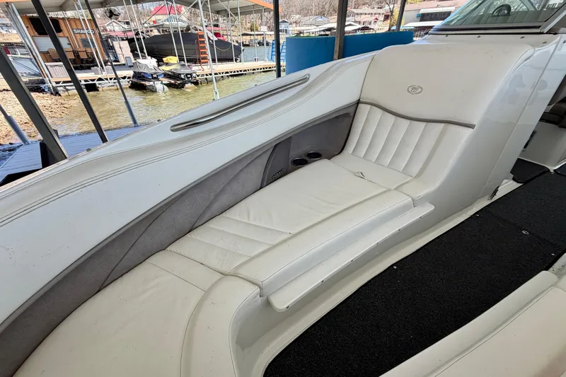 Slide: The Image of 2005 Cobalt 282 boat interior with white leather seating at a dock. - 15