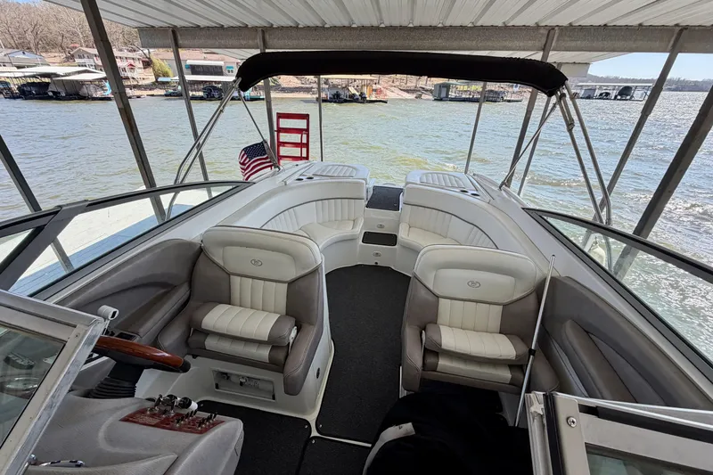 Slide: The Image of 2005 Cobalt 282 boat interior with seating, docked by the water. - 17