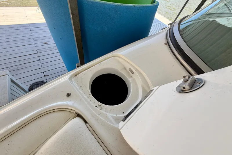 Slide: The Image of 2005 Cobalt 282 boat detail with open compartment, dockside view. - 18