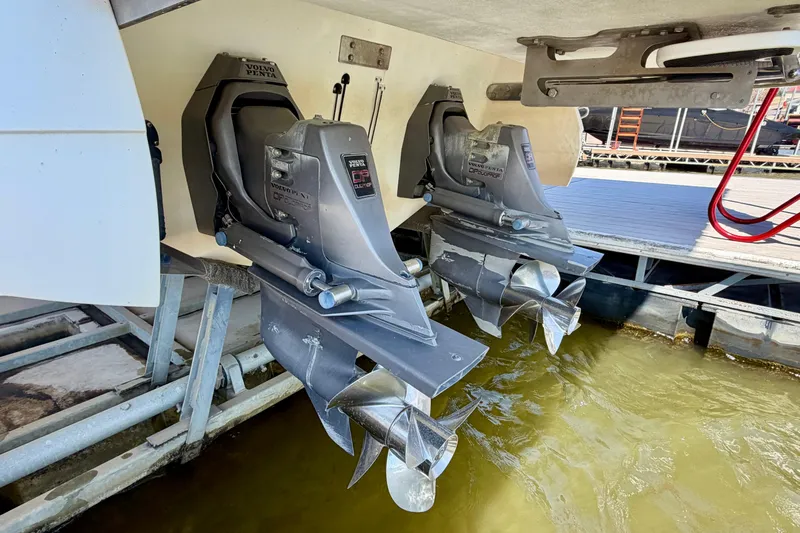 Slide: The Image of Twin Volvo Penta outdrives on a 2005 Cobalt 282 boat at a dock. - 2