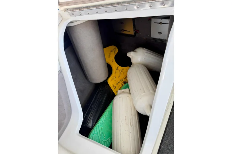 Slide: The Image of Storage compartment of a 2005 Cobalt 282 boat with fenders and equipment. - 21