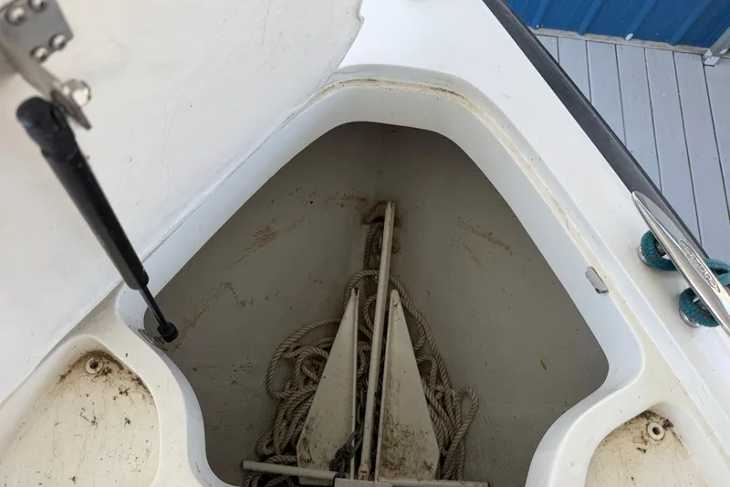 Slide: The Image of Anchor storage compartment on a 2005 Cobalt 282 boat, featuring ropes and anchor equipment. - 22