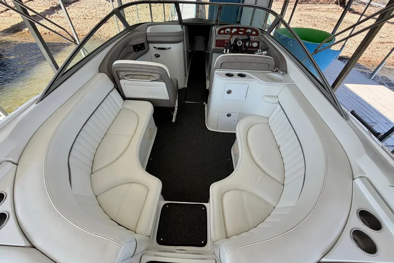 Slide: The Image of Interior of a 2005 Cobalt 282 boat with white seating and dashboard. - 3