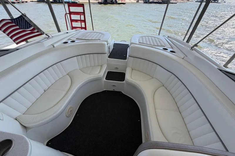 Slide: The Image of 2005 Cobalt 282 boat interior with white seating and American flag. - 4