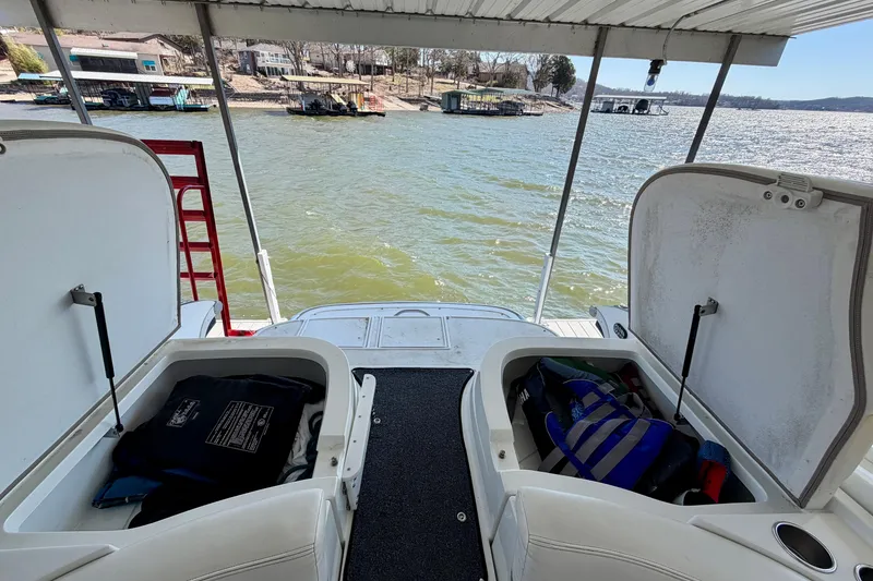 Slide: The Image of Open storage compartments on a 2005 Cobalt 282 boat, overlooking a scenic lake view. - 5