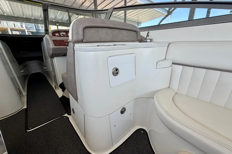 Slide: The Image of Interior of a 2005 Cobalt 282 boat, featuring white seating and dashboard controls. - 6