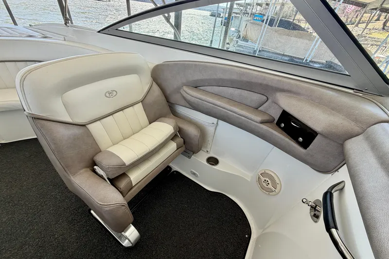 Slide: The Image of Interior of a 2005 Cobalt 282 boat featuring a plush captain's chair and dashboard. - 7