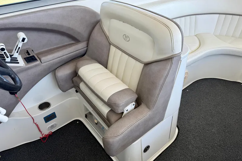 Slide: The Image of Captain's seat and controls in a 2005 Cobalt 282 boat interior. - 9