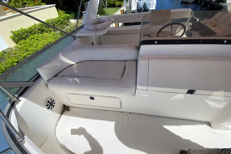Slide: The Image of 1994 Sea Ray 440 Express Bridge cockpit with white seating and steering wheel. - 19