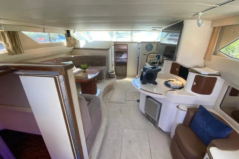 Slide: The Image of Interior of 1994 Sea Ray 440 Express Bridge yacht, featuring spacious seating and modern amenities. - 22