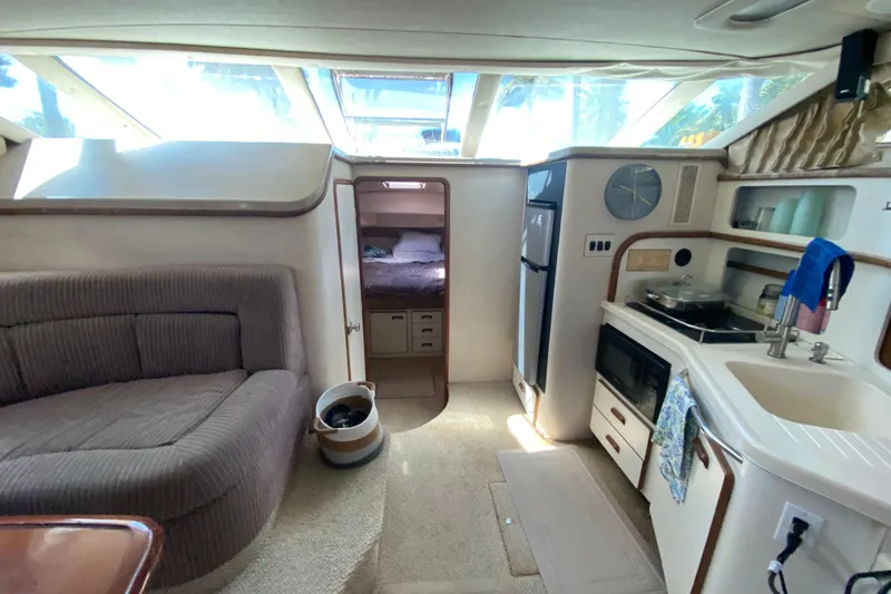 Slide: The Image of Interior of 1994 Sea Ray 440 Express Bridge yacht with kitchen and seating area. - 26