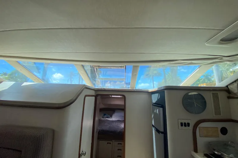 Slide: The Image of Interior view of 1994 Sea Ray 440 Express Bridge yacht with skylight and cabin. - 27