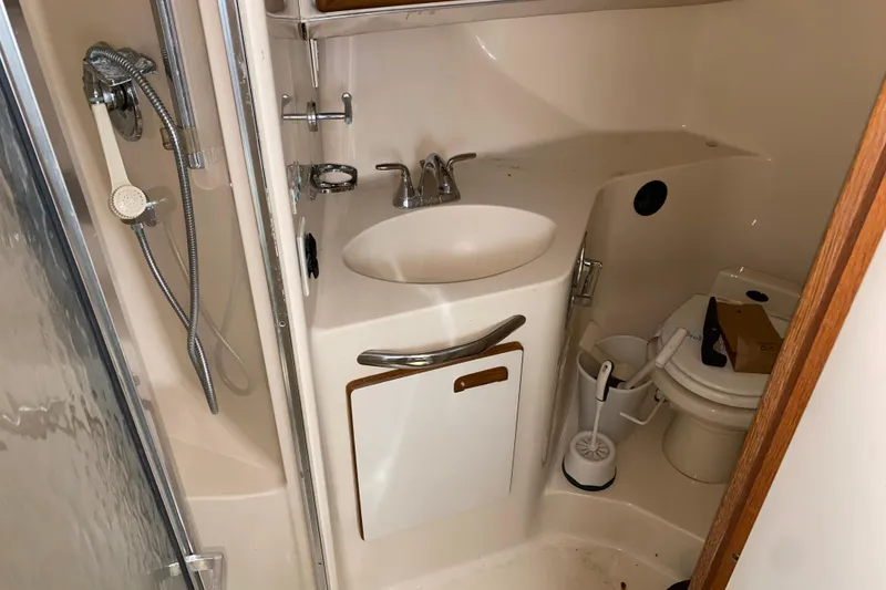Slide: The Image of Bathroom interior of 1994 Sea Ray 440 Express Bridge yacht, featuring sink and toilet. - 31