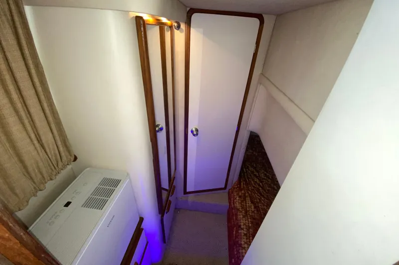 Slide: The Image of 1994 Sea Ray 440 Express Bridge cabin interior with door, curtain, and air conditioning unit. - 36