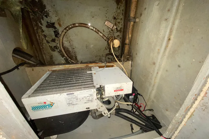 Slide: The Image of 1994 Sea Ray 440 Express Bridge engine room with air conditioning unit and wiring. - 37