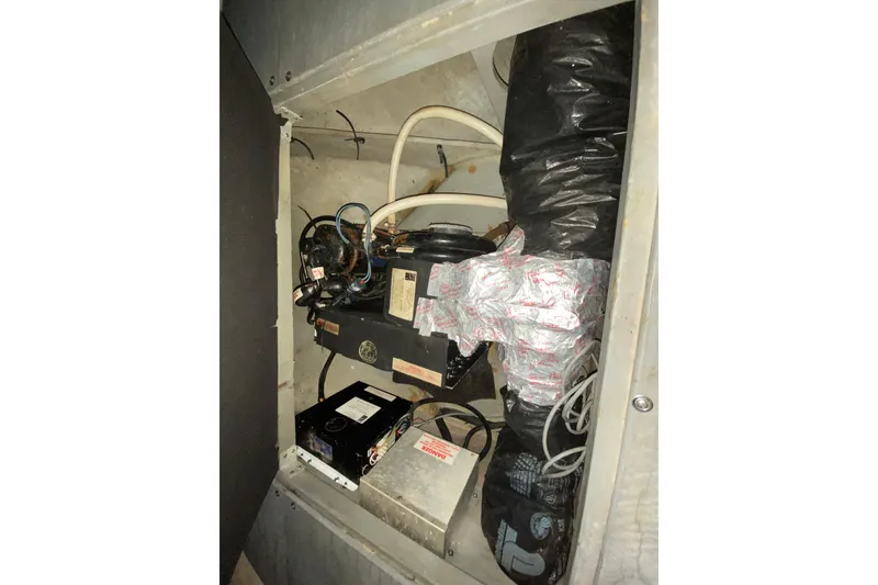 Slide: The Image of Engine compartment of a 1994 Sea Ray 440 Express Bridge boat, showing mechanical components. - 38