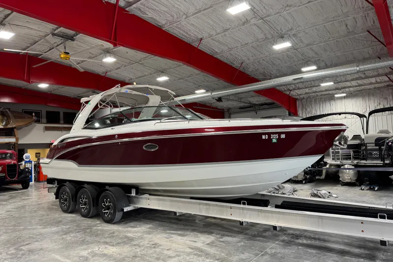 The Image of 2009 Formula 310 Bowrider boat on trailer in indoor storage facility. - 1