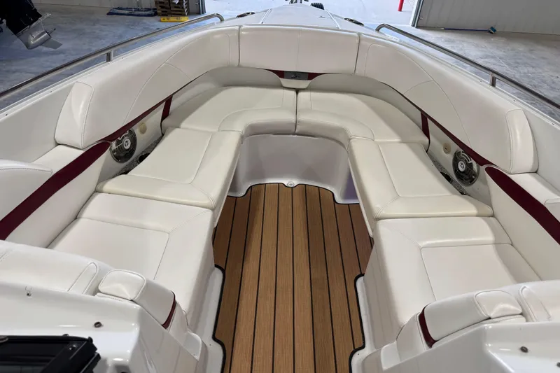 Slide: The Image of 2009 Formula 310 Bowrider interior with white seating and teak flooring in a spacious layout. - 10
