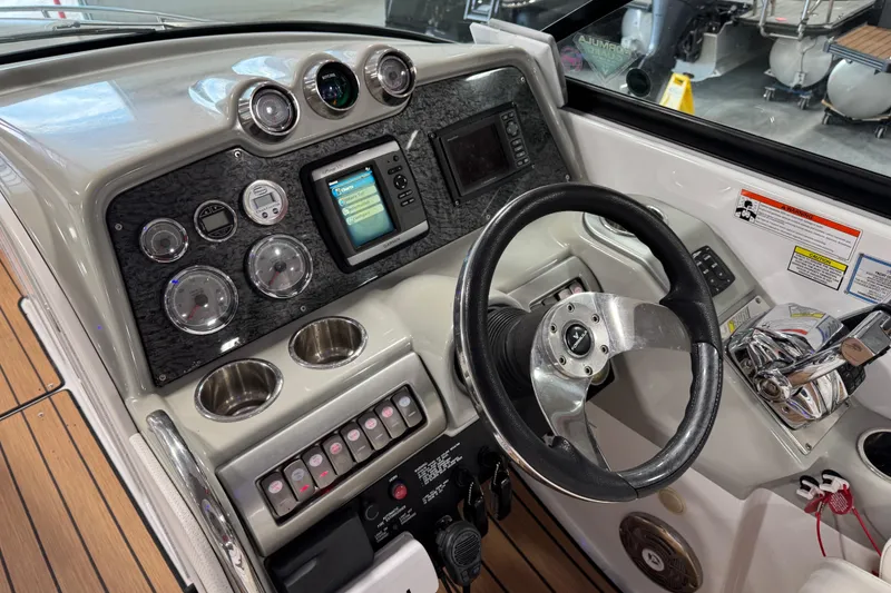 Slide: The Image of 2009 Formula 310 Bowrider dashboard with steering wheel, gauges, and navigation system. - 11