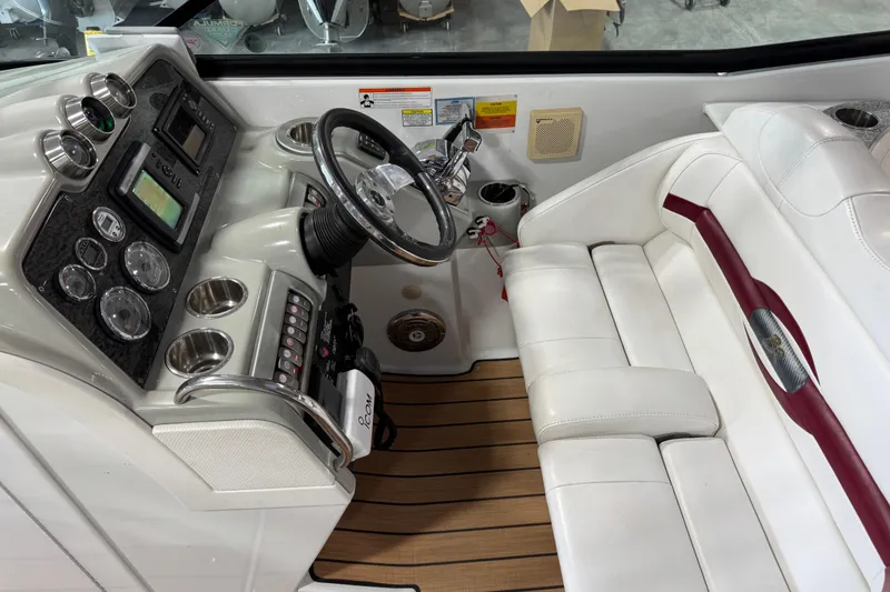 Slide: The Image of 2009 Formula 310 Bowrider cockpit with steering wheel, gauges, and white seating. - 12