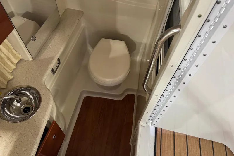 Slide: The Image of 2009 Formula 310 Bowrider bathroom with sink, toilet, and countertop. - 14