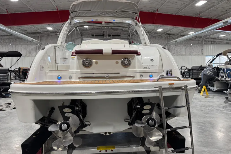 Slide: The Image of 2009 Formula 310 Bowrider boat in a showroom, rear view with dual propellers. - 5