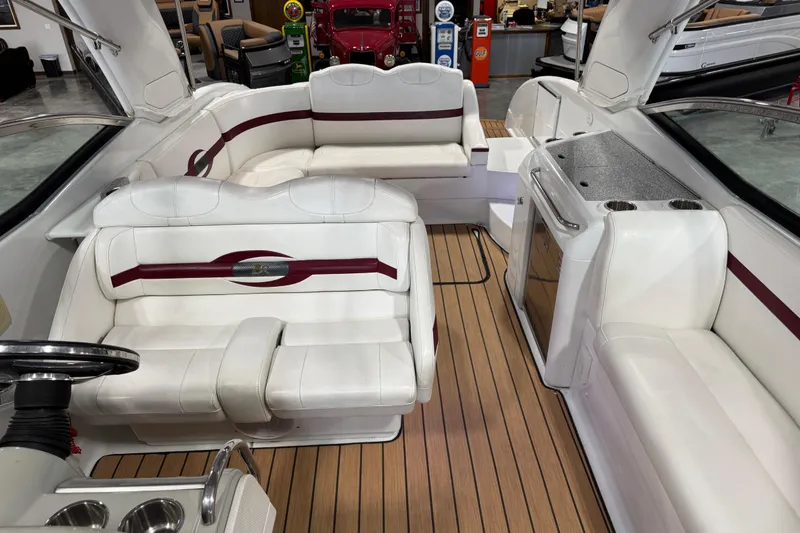 Slide: The Image of 2009 Formula 310 Bowrider interior with white seating and wood flooring. - 9