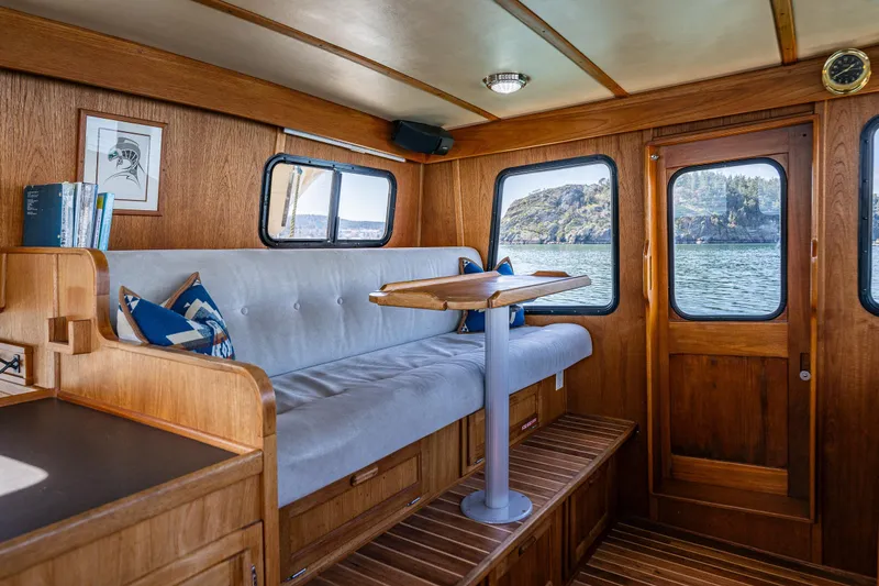 Slide: The Image of Cozy interior of a 1997 Nordic Tug 42 with wooden accents and scenic window views. - 19