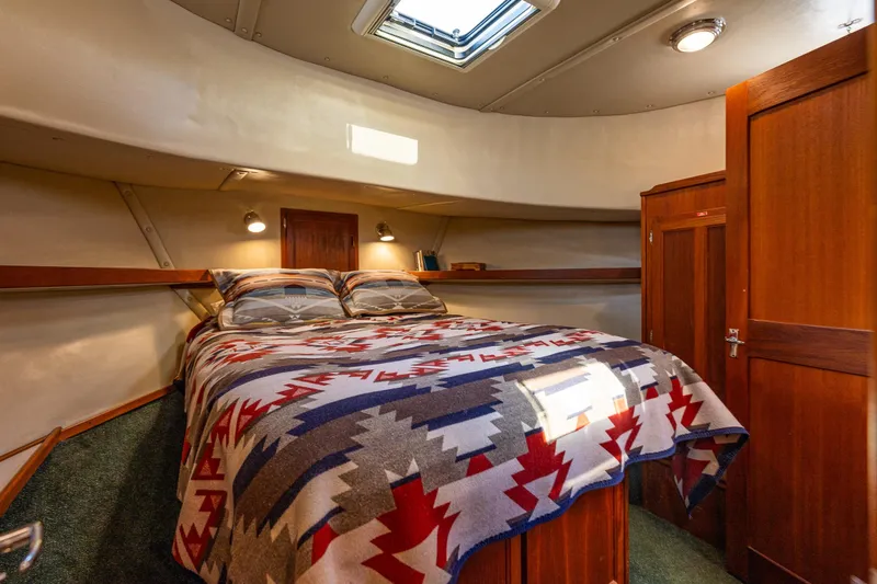 Slide: The Image of Cozy cabin interior of 1997 Nordic Tug 42 with patterned bedding and wooden accents. - 22