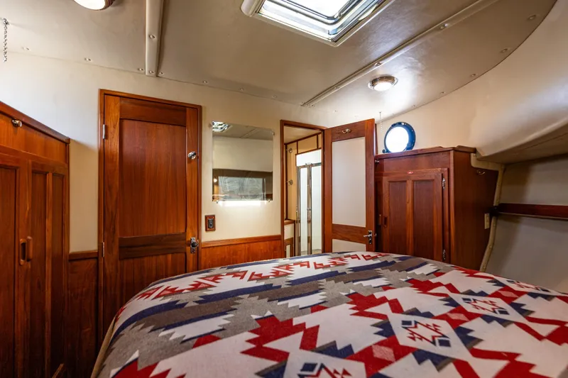 Slide: The Image of Cozy cabin interior of 1997 Nordic Tug 42 with wooden furnishings and patterned bedding. - 23
