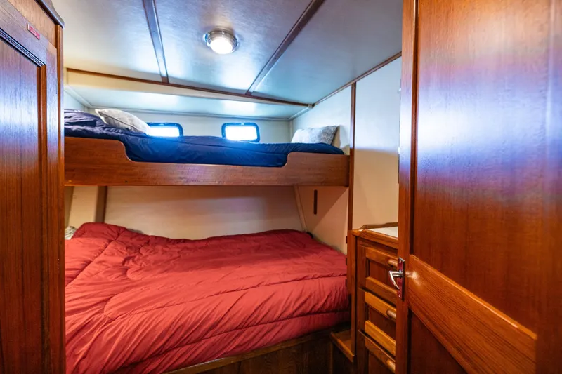 Slide: The Image of Cozy cabin with bunk beds in a 1997 Nordic Tug 42 boat interior. - 26