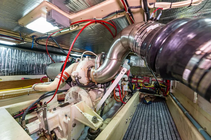 Slide: The Image of Engine room of a 1997 Nordic Tug 42 with visible machinery and wiring. - 32