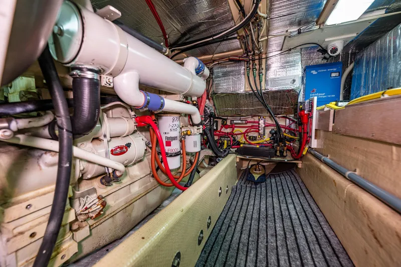 Slide: The Image of Engine room of a 1997 Nordic Tug 42, showcasing mechanical components and wiring. - 33