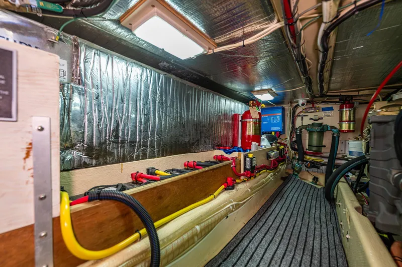 Slide: The Image of Engine room of a 1997 Nordic Tug 42, featuring wiring and equipment. - 34