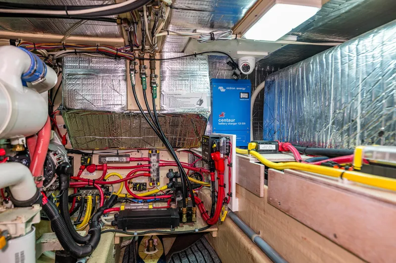 Slide: The Image of Engine room of a 1997 Nordic Tug 42, featuring wiring and a battery charger. - 35