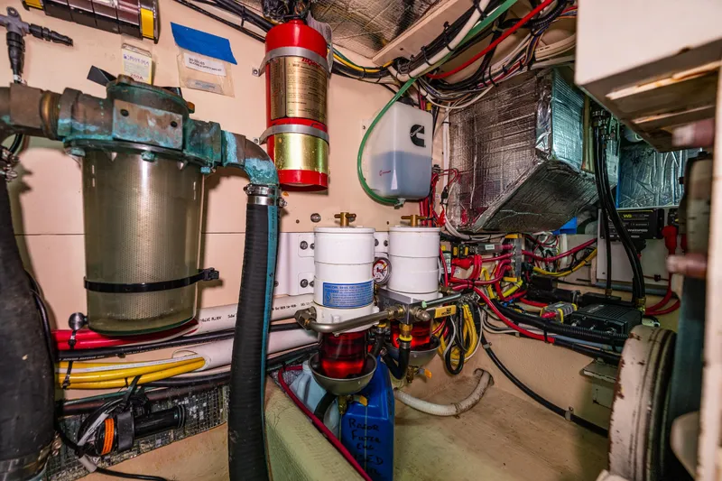 Slide: The Image of Engine room of a 1997 Nordic Tug 42, showcasing complex wiring and filtration systems. - 36