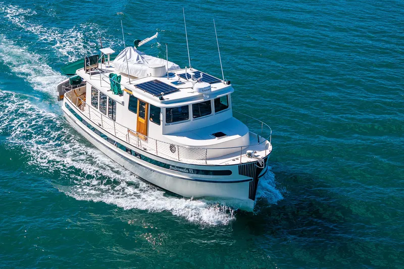 Slide: The Image of 1997 Nordic Tug 42 cruising on clear blue water, showcasing its classic design and elegance. - 41