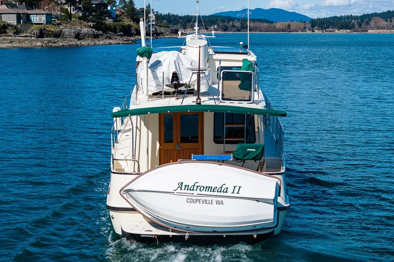 Slide: The Image of Nordic Tug 42 boat from 1997, named Andromeda II, cruising in scenic waters. - 45