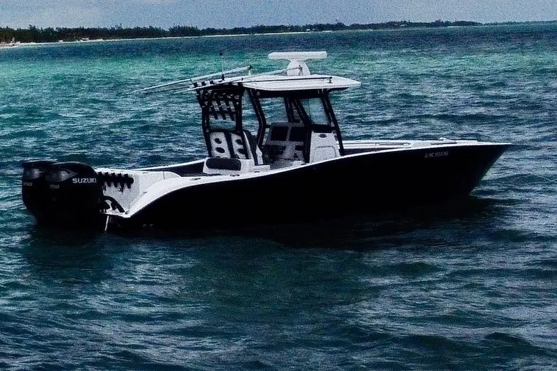 The Image of 2023 Cape Horn 32 XS boat on open water with Suzuki engines. - 1