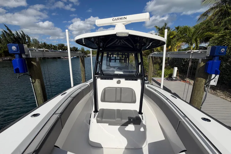 Slide: The Image of 2023 Cape Horn 32 XS boat docked, featuring Garmin equipment, under a clear blue sky. - 11