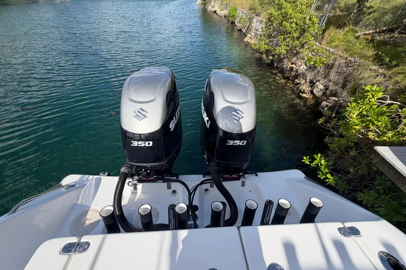 Slide: The Image of 2023 Cape Horn 32 XS boat with dual Suzuki 350 outboard engines on a calm waterway. - 19