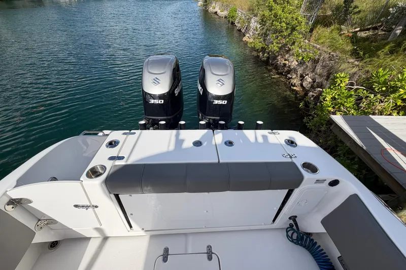 Slide: The Image of 2023 Cape Horn 32 XS boat with dual Suzuki 350 engines on a serene waterway. - 20