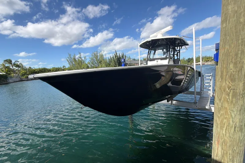 Slide: The Image of 2023 Cape Horn 32 XS boat docked on a lift under a clear blue sky. - 3