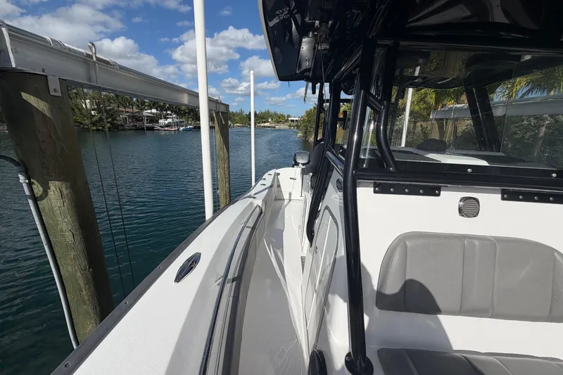 Slide: The Image of 2023 Cape Horn 32 XS boat docked by a scenic waterfront under a blue sky. - 9