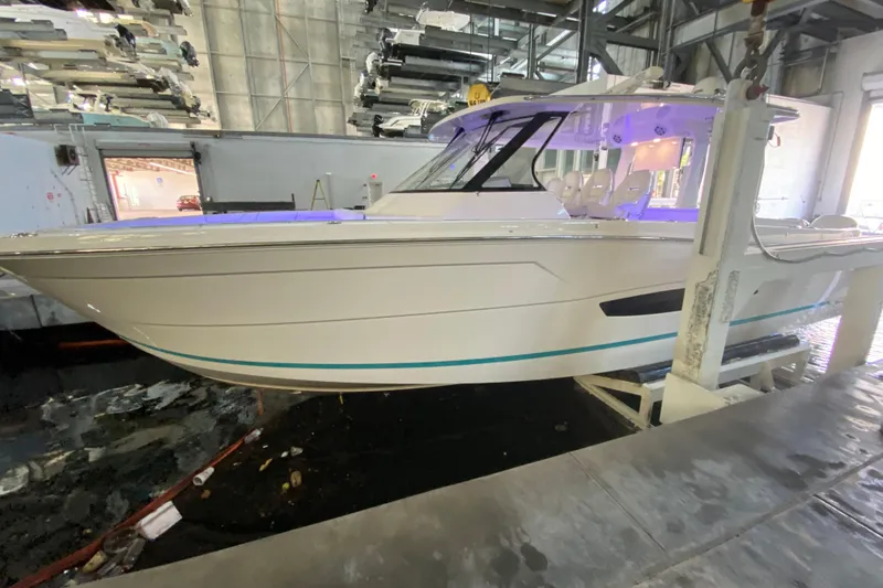 The Image of 2021 Regal 38 SAV boat in indoor storage facility, side view. - 0