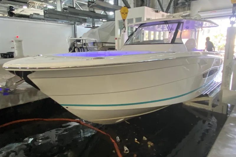 Slide: The Image of 2021 Regal 38 SAV boat displayed indoors with modern design and sleek lines. - 10