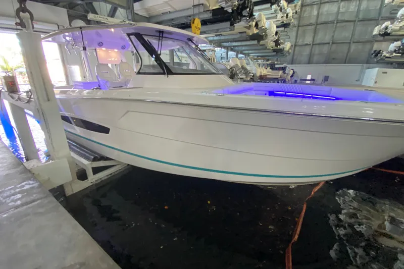 Slide: The Image of 2021 Regal 38 SAV boat in indoor storage with blue accent lighting. - 14