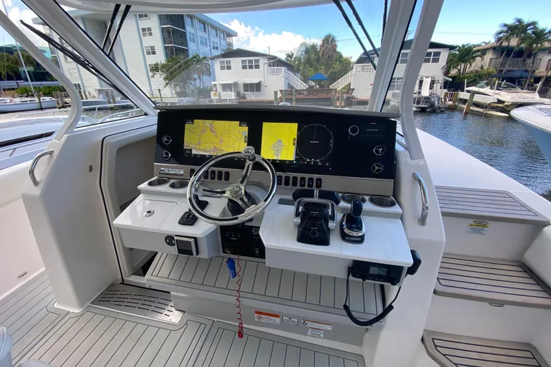 Slide: The Image of 2021 Regal 38 SAV boat helm with modern navigation displays and controls. - 29
